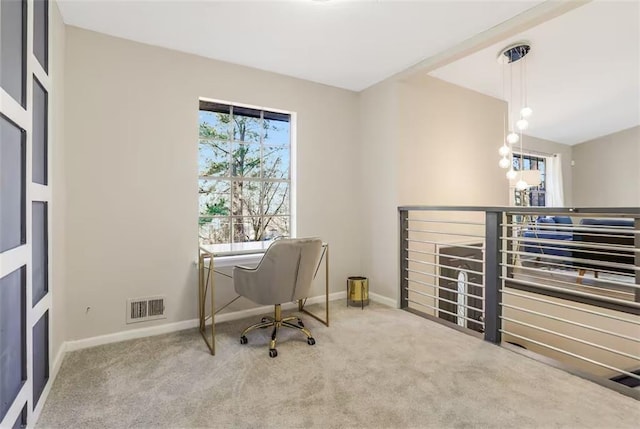 office space with carpet flooring and a chandelier