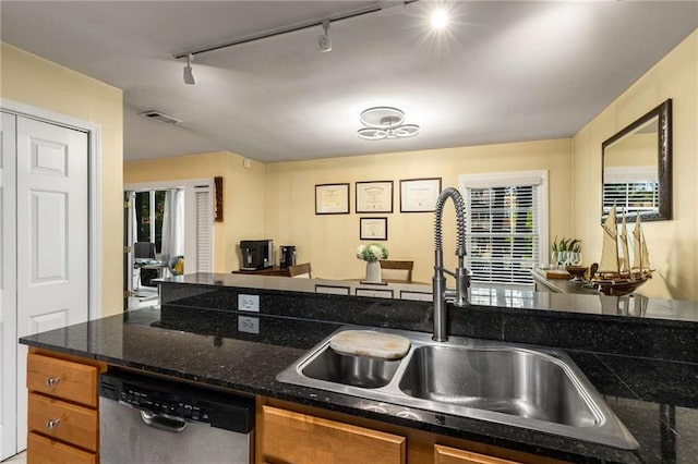 1445 Monroe Dr NE Unit 14B, Atlanta, GA 30324 - kitchen with stainless steel dishwasher, track lighting, and brown cabinets