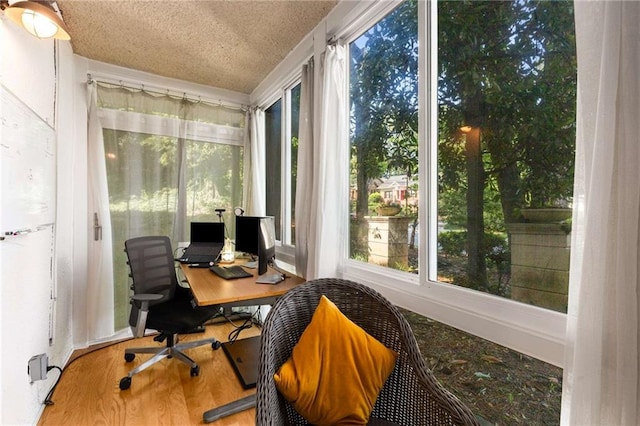 1445 Monroe Dr NE Unit 14B, Atlanta, GA 30324 - office area with wood finished floors, plenty of natural light, and a textured ceiling