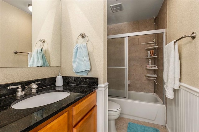 1445 Monroe Dr NE Unit 14B, Atlanta, GA 30324 - full bathroom with tile patterned flooring, vanity, bath / shower combo with glass door, and a textured wall