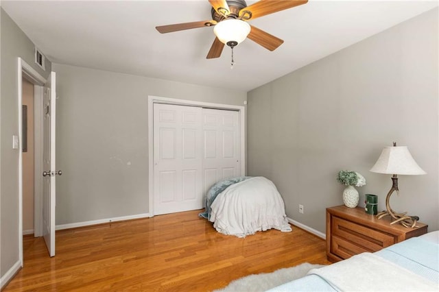 1445 Monroe Dr NE Unit 14B, Atlanta, GA 30324 - bedroom featuring wood finished floors, a closet, and ceiling fan