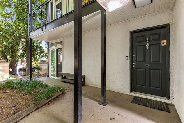 1445 Monroe Dr NE Unit 14B, Atlanta, GA 30324 - doorway to property featuring stucco siding and a balcony
