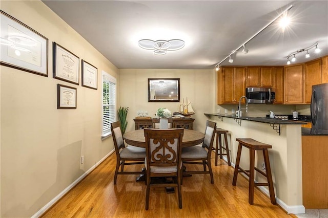 1445 Monroe Dr NE Unit 14B, Atlanta, GA 30324 - dining space featuring light wood-style floors and baseboards