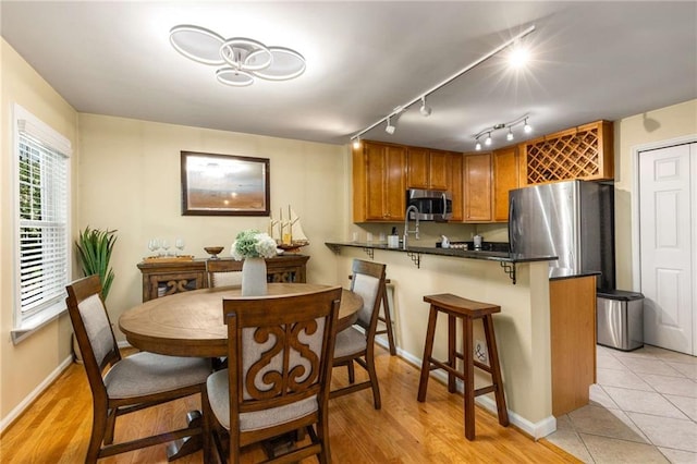 1445 Monroe Dr NE Unit 14B, Atlanta, GA 30324 - dining room with light wood-type flooring and track lighting