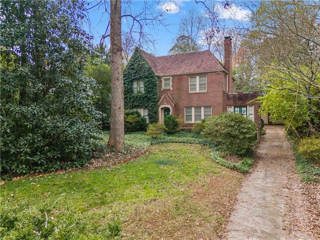 1080 Clifton Rd NE, Atlanta, GA 30307 - tudor house with a chimney, brick siding, and a front lawn