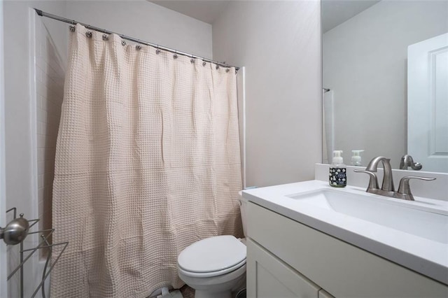 bathroom with toilet and large vanity