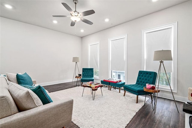 sitting room featuring ceiling fan and dark wood-type flooring