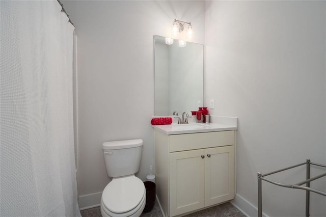 bathroom featuring toilet and vanity