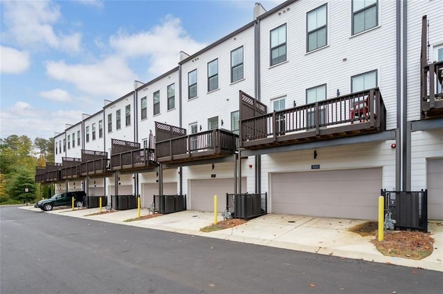 view of property featuring central AC and a garage