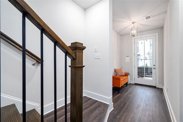 foyer featuring a chandelier and dark hardwood / wood-style flooring