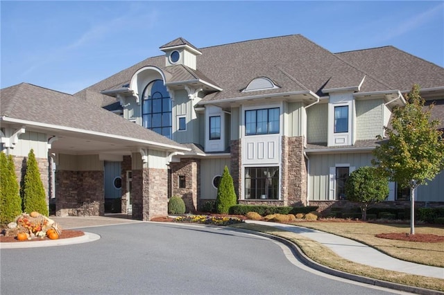 3678 Cresswind Pkwy SW, Gainesville, GA 30504 - view of front of home with board and batten siding, stone siding, and a shingled roof
