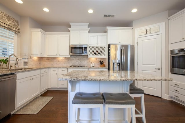 3678 Cresswind Pkwy SW, Gainesville, GA 30504 - kitchen featuring appliances with stainless steel finishes, a sink, white cabinetry, and recessed lighting
