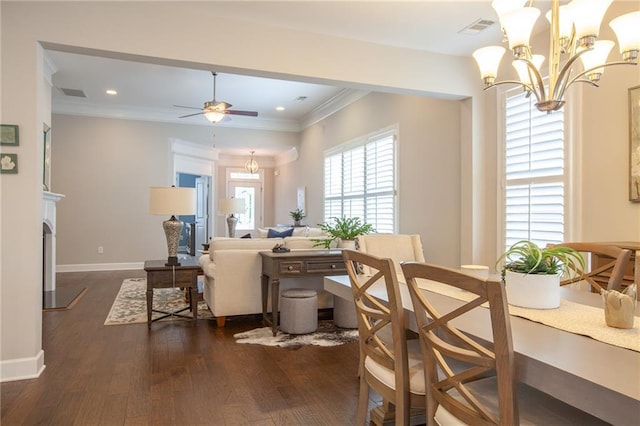3678 Cresswind Pkwy SW, Gainesville, GA 30504 - dining area with a chandelier, dark wood-style floors, a ceiling fan, crown molding, and baseboards