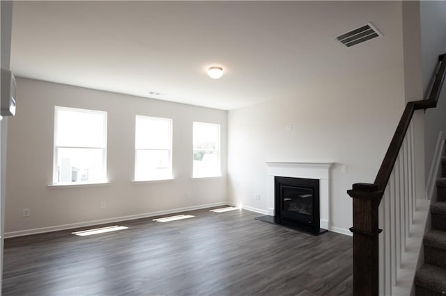 unfurnished living room with dark hardwood / wood-style floors