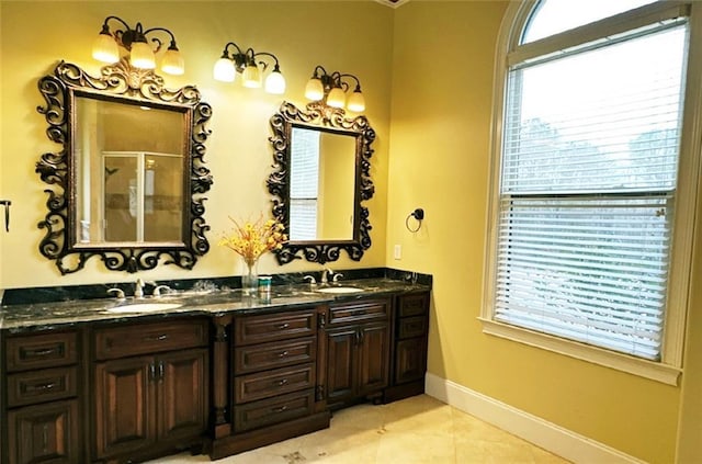 bathroom with vanity, plenty of natural light, a shower with door, and tile patterned flooring