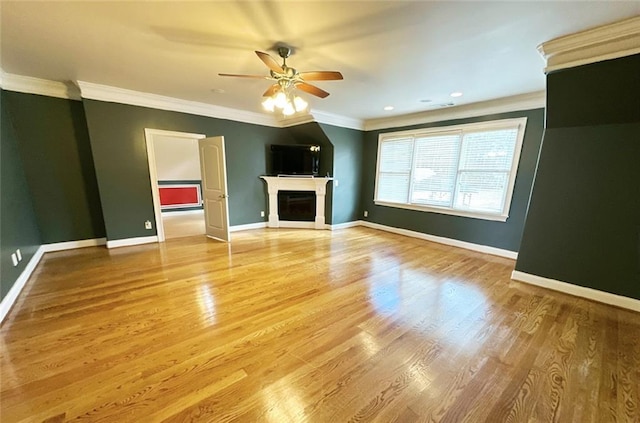 unfurnished living room featuring light hardwood / wood-style floors, ceiling fan, and ornamental molding