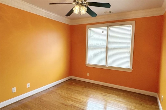 spare room with ceiling fan, crown molding, and light hardwood / wood-style floors