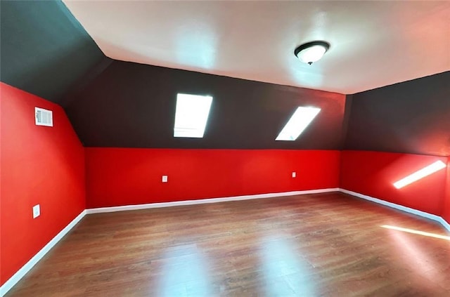 bonus room featuring hardwood / wood-style floors and lofted ceiling