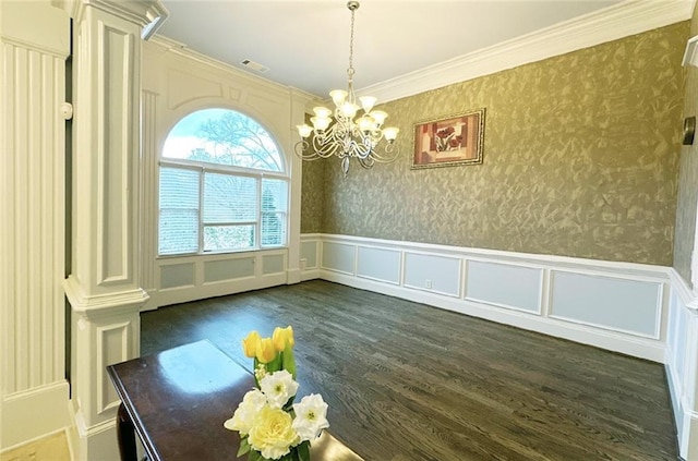 unfurnished dining area with a notable chandelier, crown molding, and dark wood-type flooring