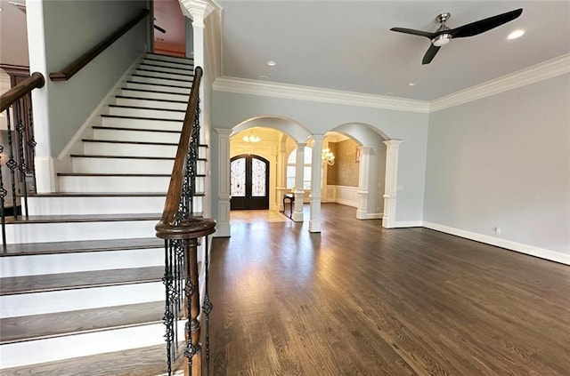 stairway featuring hardwood / wood-style floors, ornate columns, french doors, ceiling fan, and crown molding