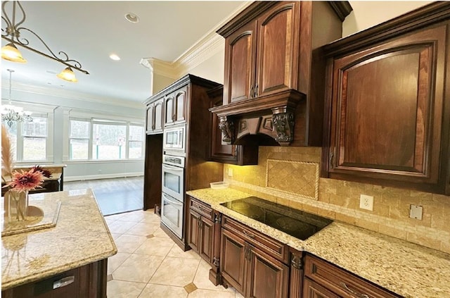 kitchen with appliances with stainless steel finishes, decorative light fixtures, backsplash, light stone countertops, and light tile patterned flooring