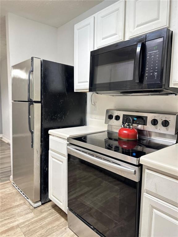 kitchen with white cabinetry and stainless steel appliances