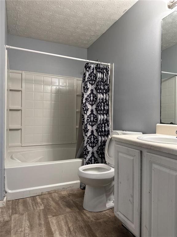 full bathroom featuring a textured ceiling, vanity, shower / bath combo, and toilet