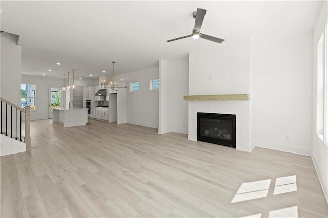 1937 Quarry Park Pl NW, Atlanta, GA 30318 - unfurnished living room featuring a fireplace, a chandelier, recessed lighting, light wood-style flooring, and healthy amount of natural light