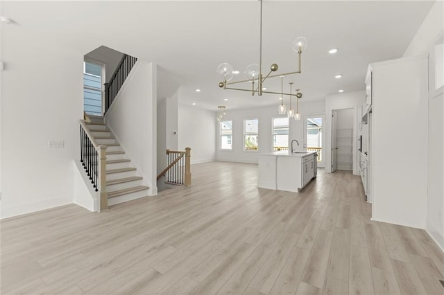 1937 Quarry Park Pl NW, Atlanta, GA 30318 - unfurnished living room with light wood-type flooring, a sink, stairs, a chandelier, and recessed lighting