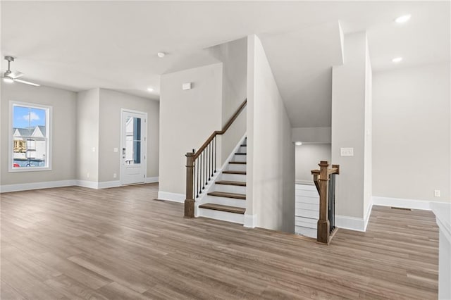 entrance foyer with recessed lighting, ceiling fan, wood finished floors, baseboards, and stairs