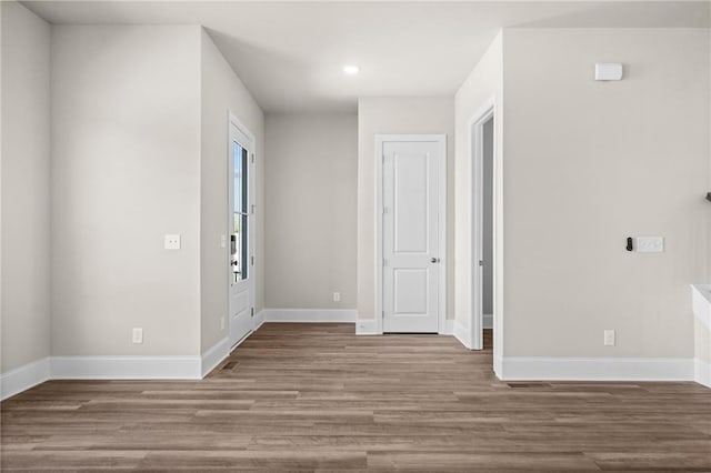 entrance foyer with recessed lighting, wood finished floors, and baseboards