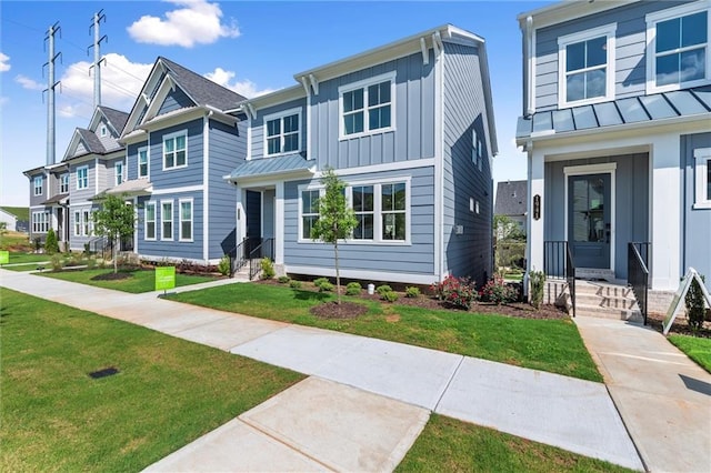 1937 Quarry Park Pl NW, Atlanta, GA 30318 - townhome / multi-family property featuring board and batten siding, a front lawn, a standing seam roof, metal roof, and a residential view