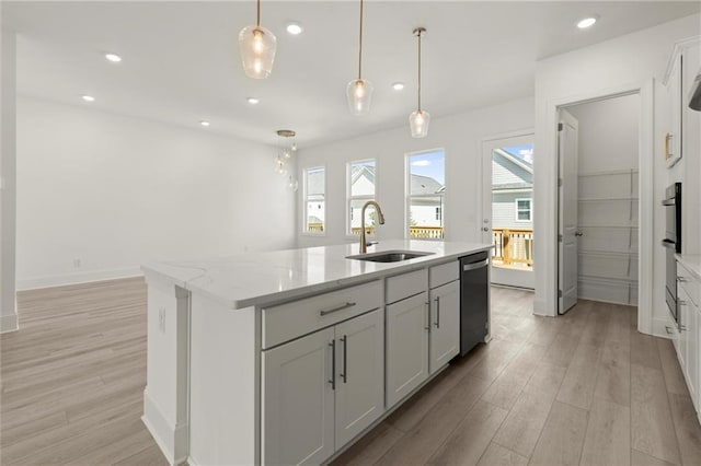 1937 Quarry Park Pl NW, Atlanta, GA 30318 - kitchen featuring a sink, stainless steel dishwasher, light wood-style floors, a kitchen island with sink, and pendant lighting