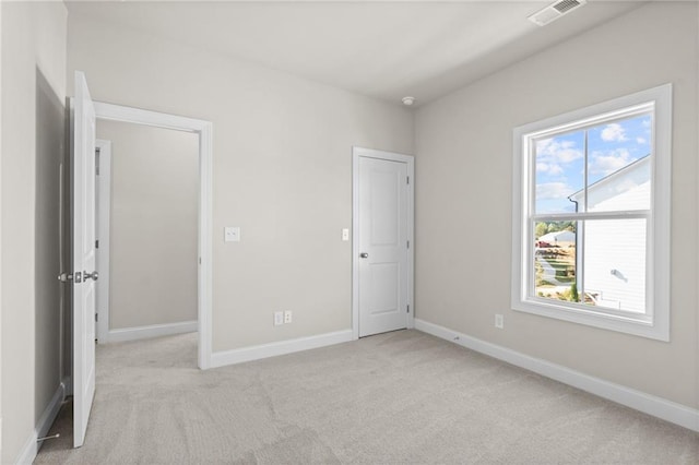 unfurnished bedroom featuring carpet, visible vents, and baseboards