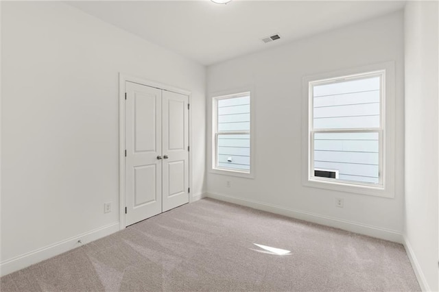 1937 Quarry Park Pl NW, Atlanta, GA 30318 - unfurnished bedroom with carpet, baseboards, and a closet