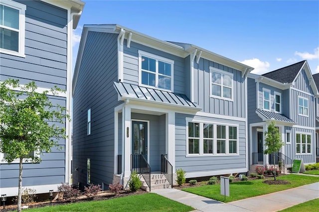 1937 Quarry Park Pl NW, Atlanta, GA 30318 - view of front of house with a standing seam roof, a front yard, board and batten siding, and metal roof