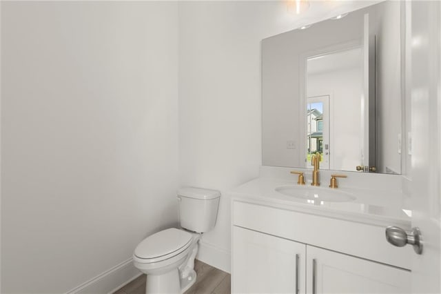 1937 Quarry Park Pl NW, Atlanta, GA 30318 - half bathroom featuring toilet, vanity, baseboards, and wood finished floors