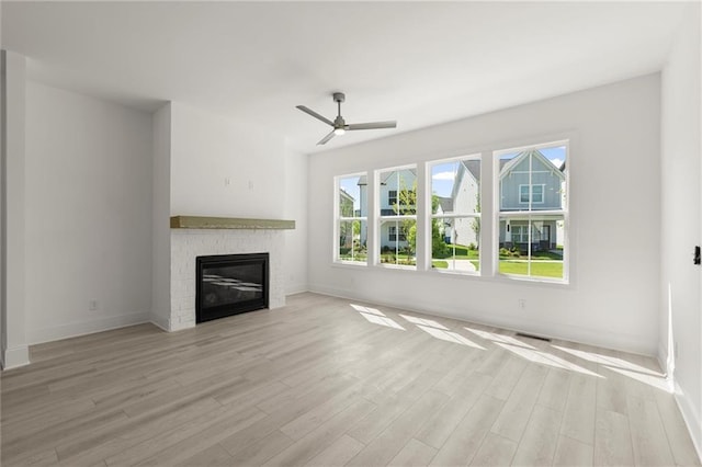 1937 Quarry Park Pl NW, Atlanta, GA 30318 - unfurnished living room featuring light wood-style flooring, baseboards, a brick fireplace, and a ceiling fan