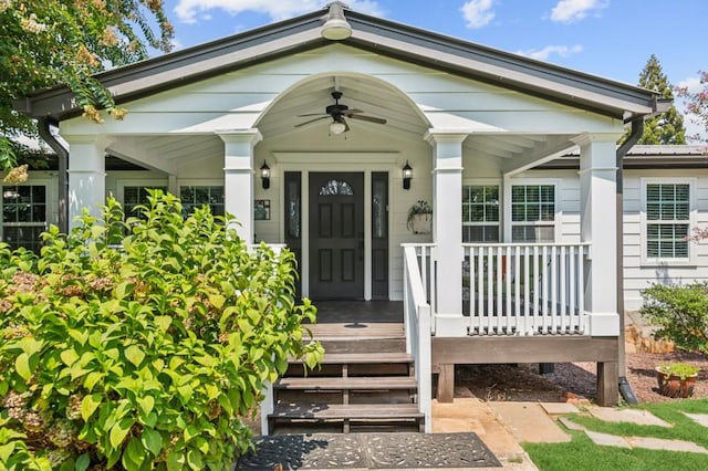 entrance to property featuring a porch and ceiling fan