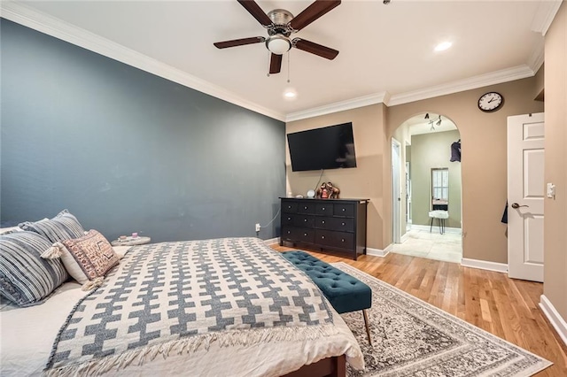 3777 Peachtree Rd NE Unit 438, Brookhaven, GA 30319 - bedroom with arched walkways, light wood-style floors, crown molding, ceiling fan, and recessed lighting