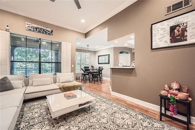 3777 Peachtree Rd NE Unit 438, Brookhaven, GA 30319 - living room featuring ornamental molding, a ceiling fan, light wood-style flooring, and recessed lighting