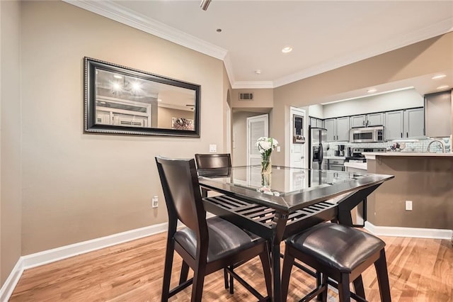 3777 Peachtree Rd NE Unit 438, Brookhaven, GA 30319 - dining room featuring light wood-style floors, ornamental molding, and recessed lighting