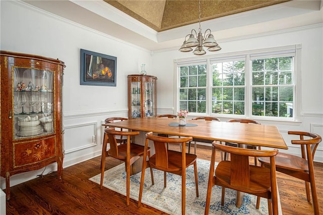2355 Quail Creek Ter, Buford, GA 30519 - dining area featuring dark wood-style floors, a chandelier, a decorative wall, ornamental molding, and wainscoting