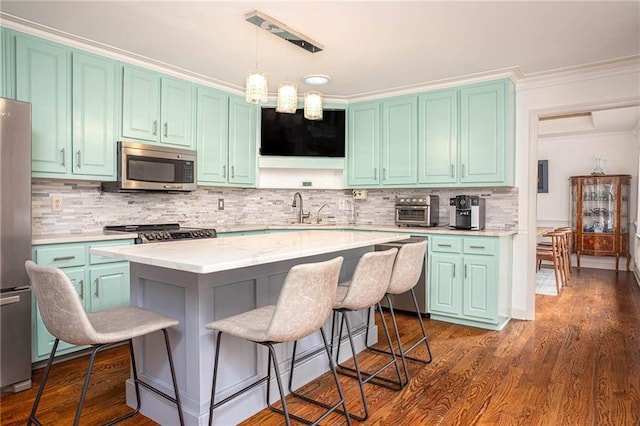 2355 Quail Creek Ter, Buford, GA 30519 - kitchen with stainless steel appliances, a kitchen breakfast bar, tasteful backsplash, decorative light fixtures, and crown molding