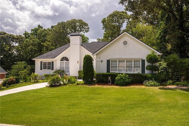 2355 Quail Creek Ter, Buford, GA 30519 - view of front of home with a front lawn, a chimney, and stucco siding