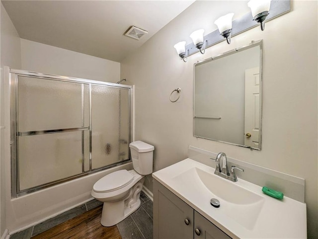2355 Quail Creek Ter, Buford, GA 30519 - bathroom featuring vanity, wood finished floors, and combined bath / shower with glass door