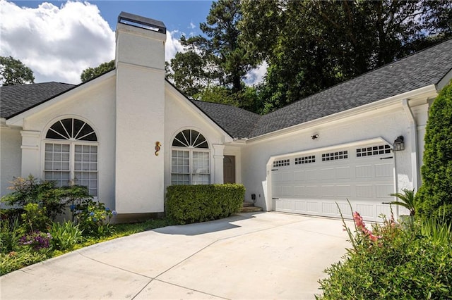 2355 Quail Creek Ter, Buford, GA 30519 - view of front of home with an attached garage, driveway, a chimney, and a shingled roof