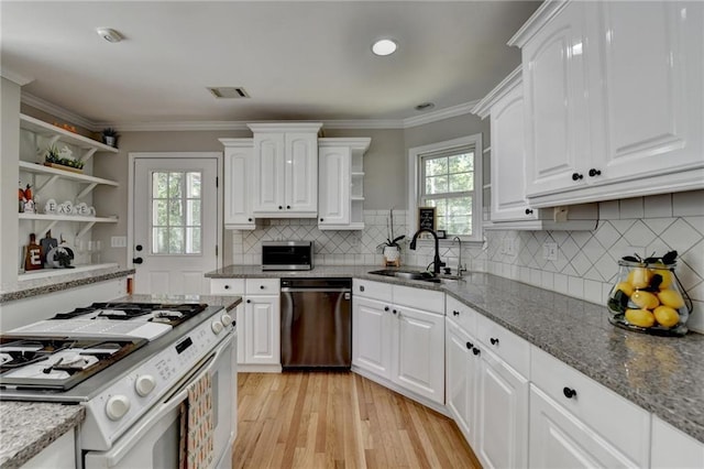 kitchen with white range with gas cooktop, open shelves, visible vents, dishwasher, and a sink