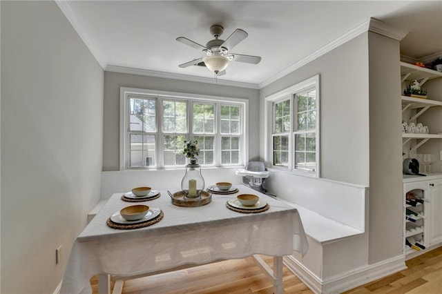 dining room featuring crown molding, wood finished floors, and a ceiling fan