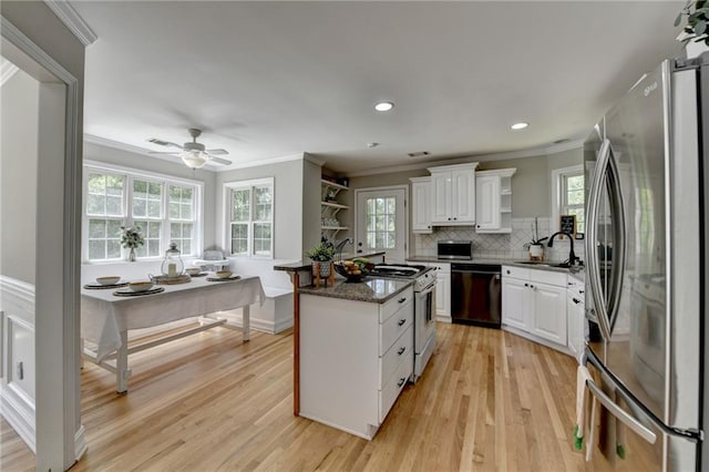 kitchen with dishwasher, freestanding refrigerator, open shelves, and gas range gas stove